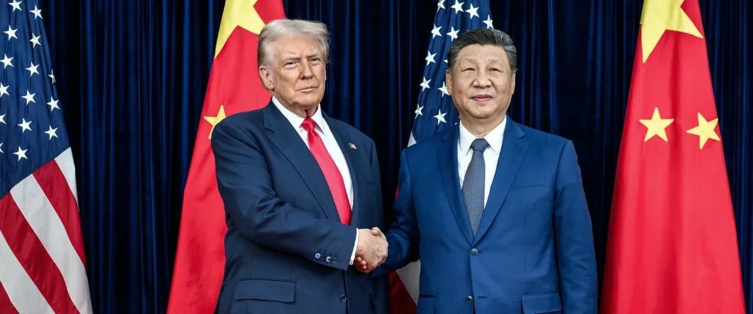 Donald Trump and Xi Jinping shaking hands in front of the flags of the United States and China
